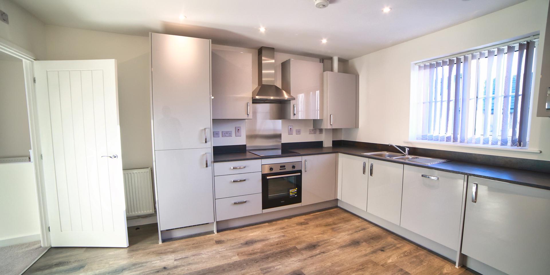 The kitchen diner has integrated appliances including washing machine, dishwasher and fridge freezer