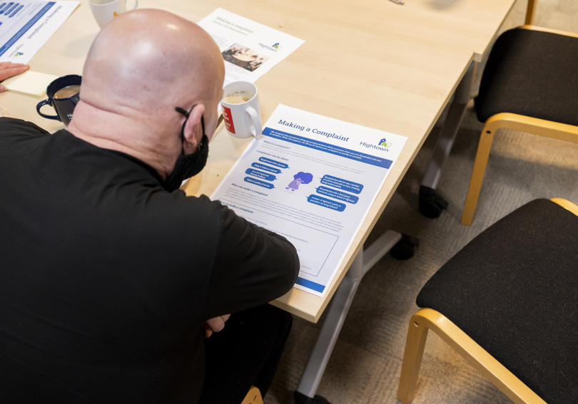 A service user reviewing a leaflet at Hightown House