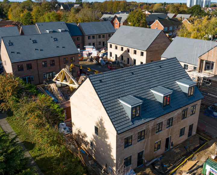 New build houses which have just been completed; there is some scaffolding still up. 