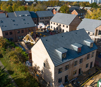 New build houses which have just been completed; there is some scaffolding still up. 