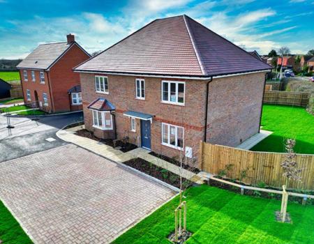 Birdseye view of the front of the property with its allocated parking spaces and the house next door