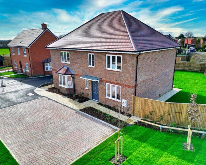 Birdseye view of the front of the property with its allocated parking spaces and the house next door