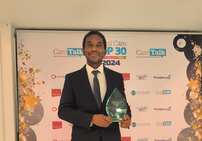 Francis Zvoma With His Award