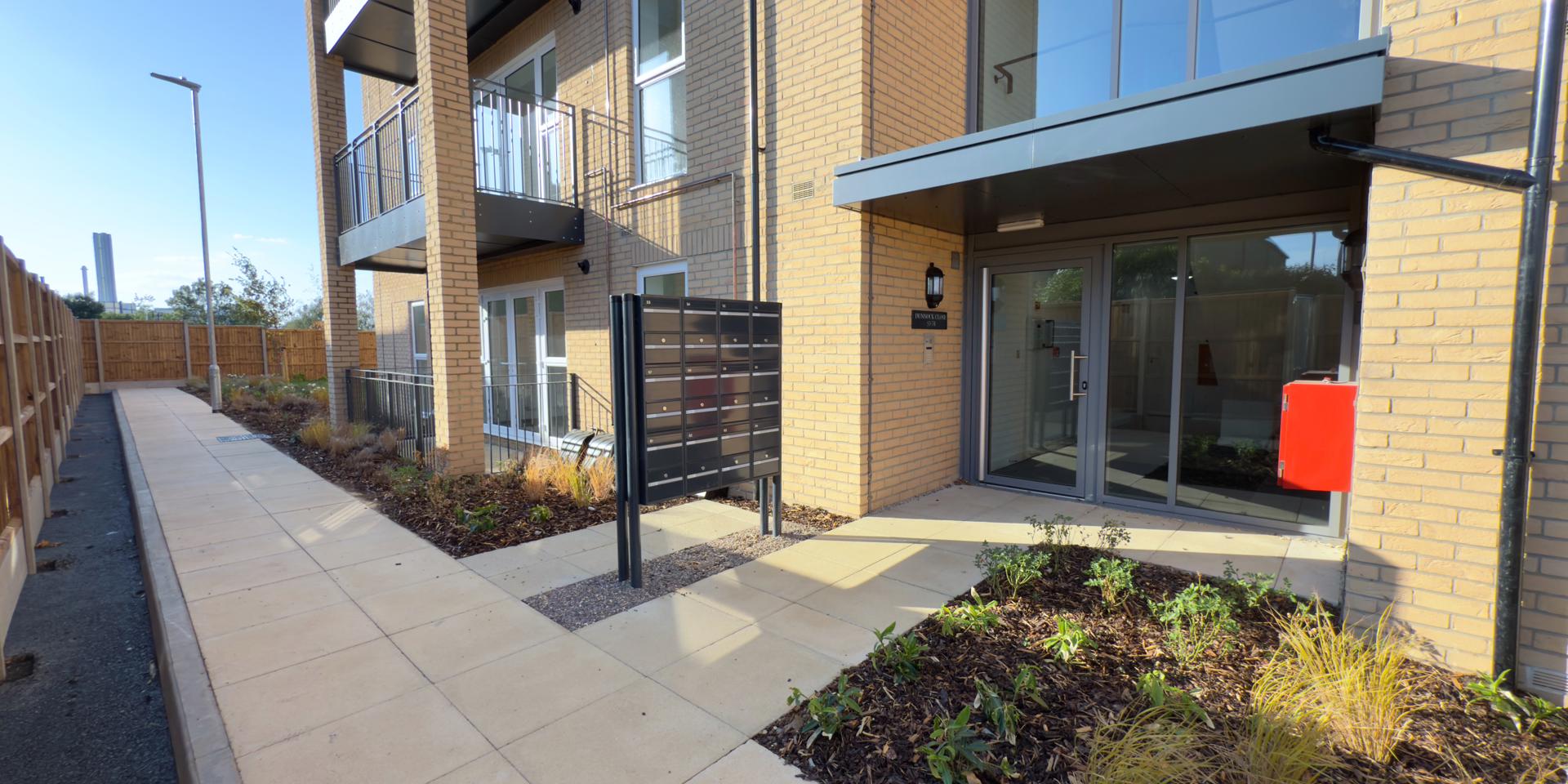 The letter boxes are located outside the building