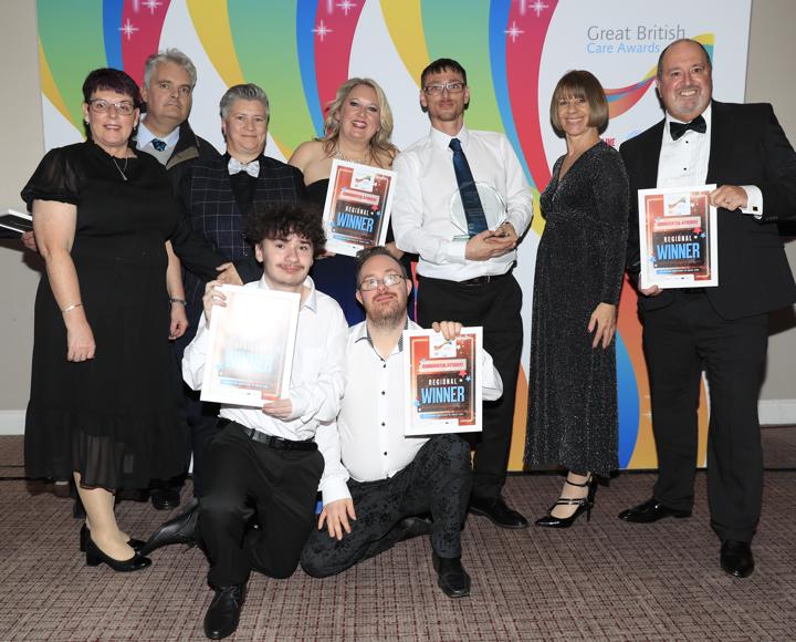 Staff and service users in black tie dress at the voicebox awards. 