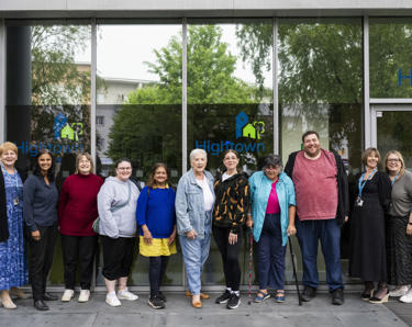 A photo of Hightowns VoiceBox group smiling together outside of Hightown House