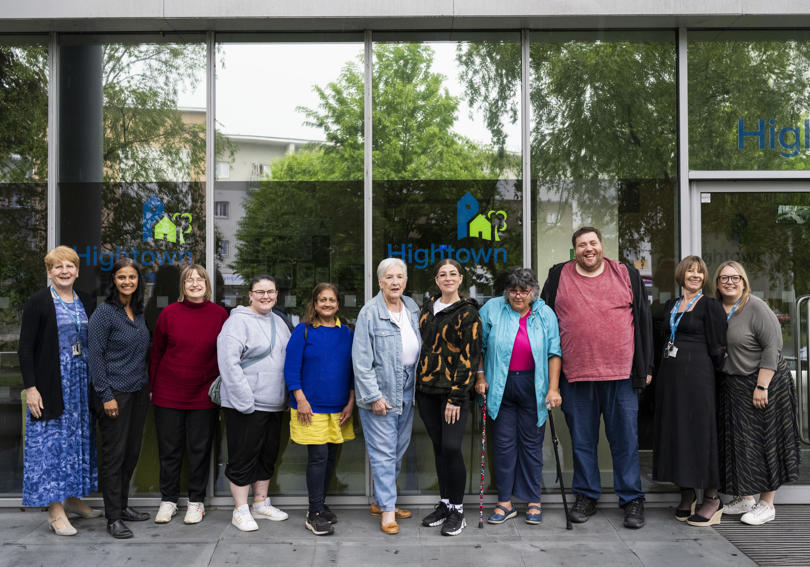 A photo of Hightowns VoiceBox group smiling together outside of Hightown House