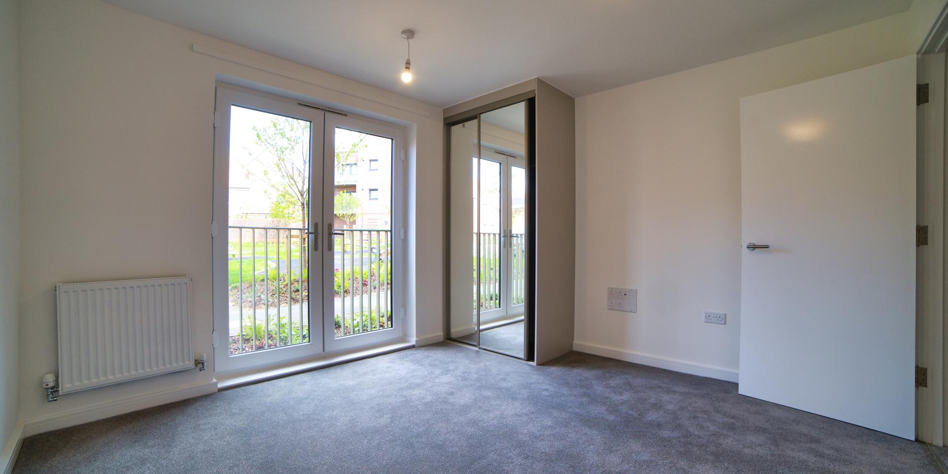 The double bedroom has a built-in mirrored wardrobe and Juliette balcony