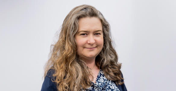 Headshot of Cordelia Pace, Vice-Chair of Hightown's Board. She has long, wavy, blonde/brown hair and is wearing a navy and white floral top.