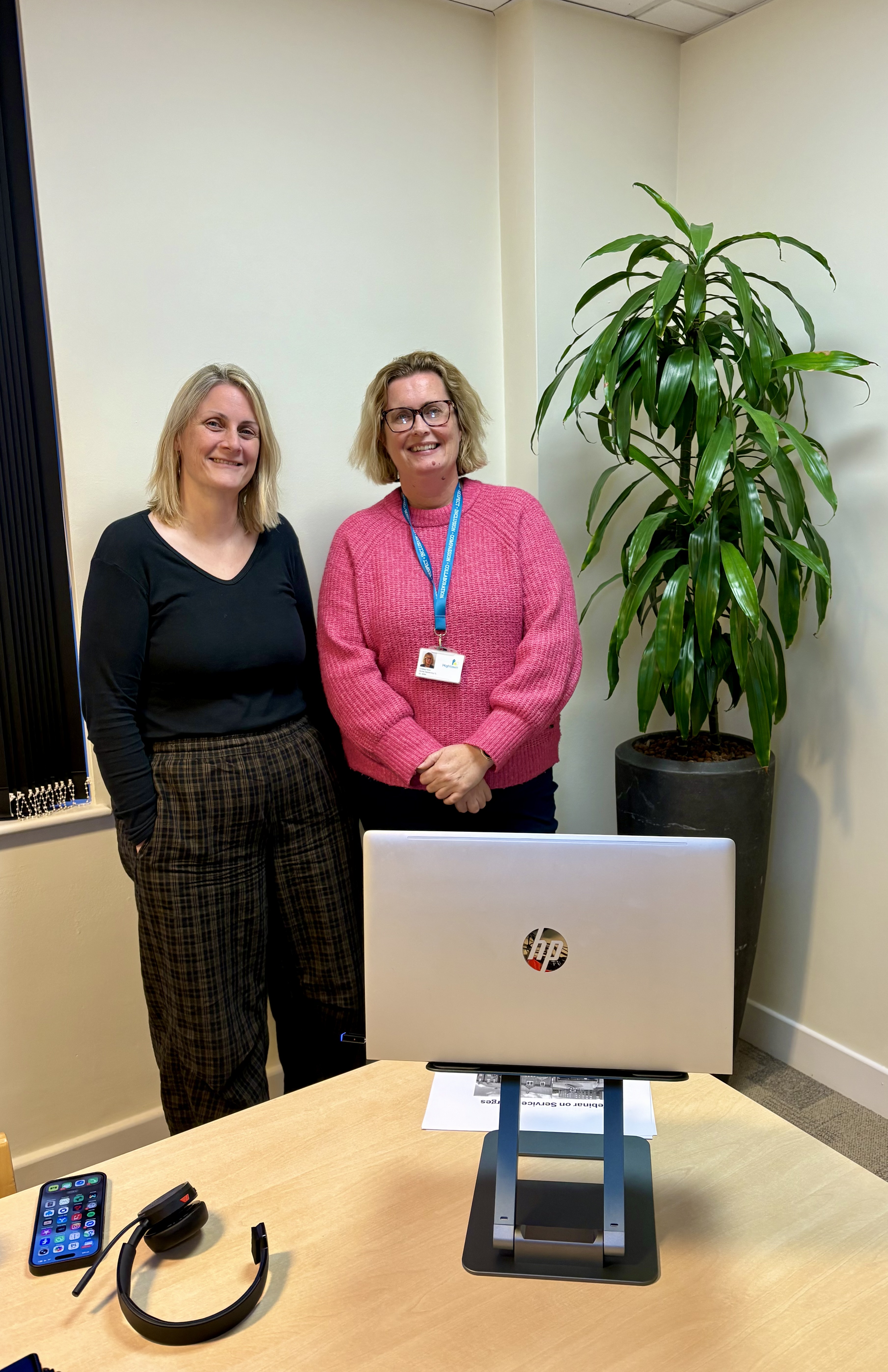 Donna Spikings and Lindsay Fenn standing behind a laptop