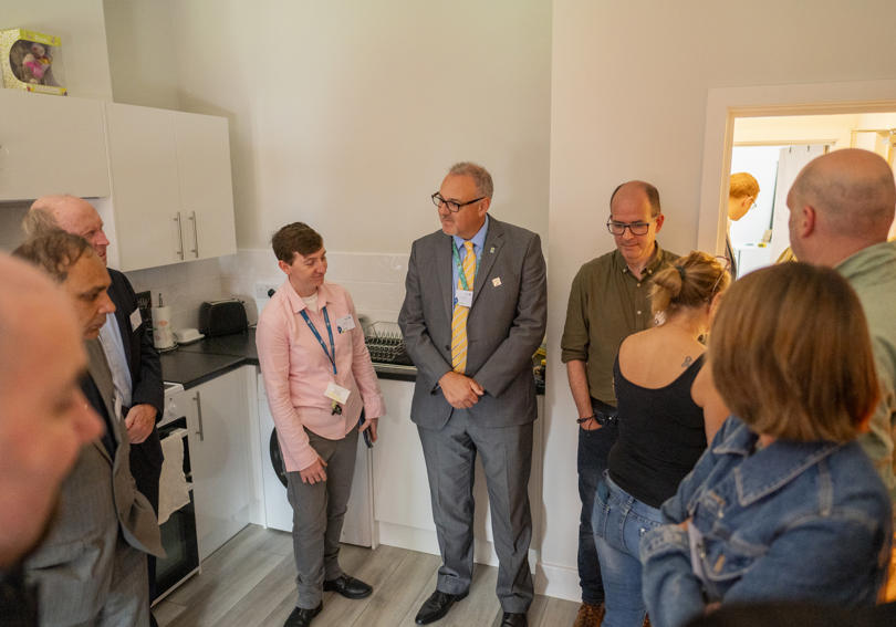 David Bogle and staff members speaking in the kitchen at Alexandra Road's opening
