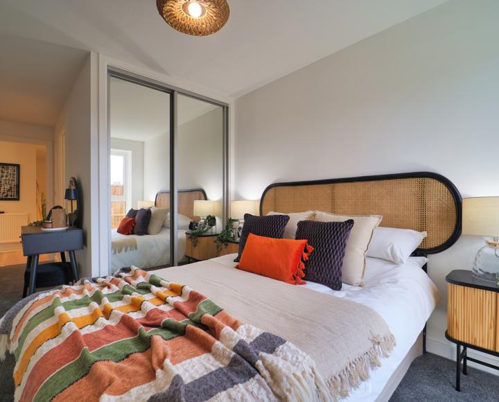 The main bedroom has a double bed, built-in double mirrored wardrobe, bedside tables and dressing table