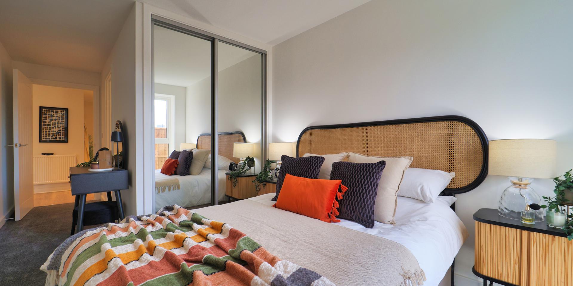 The main bedroom has a double bed, built-in double mirrored wardrobe, bedside tables and dressing table