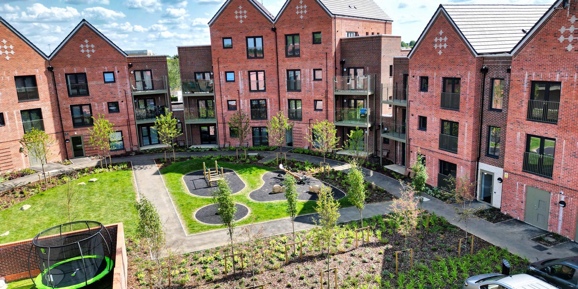 An elevated view showing the play area behind the apartments