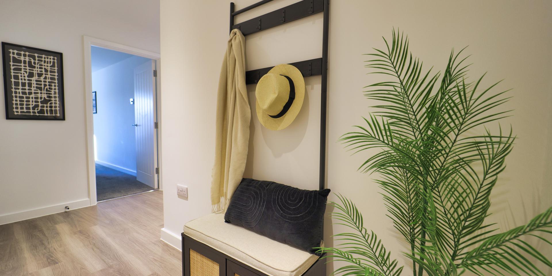 There is an all-in-one coat stand and seat in the hallway entrance