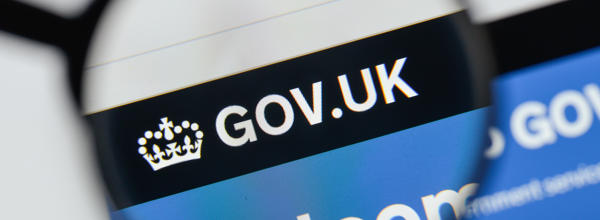 A magnifying glass over the homepage of the gov.uk website.