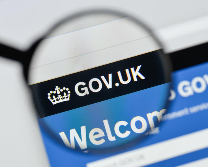 A magnifying glass over the homepage of the gov.uk website.