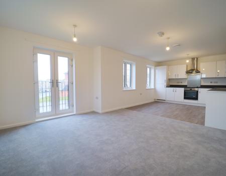 The living area is open plan to the kicthe/diner and has a Juliette balcony and window.