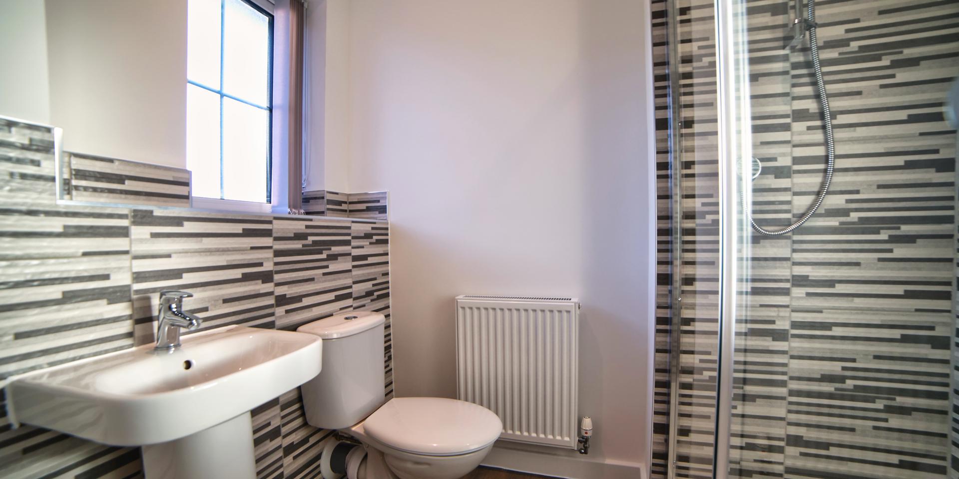 The en-suite has an enclosed shower cubicle, wash hand basin and toilet