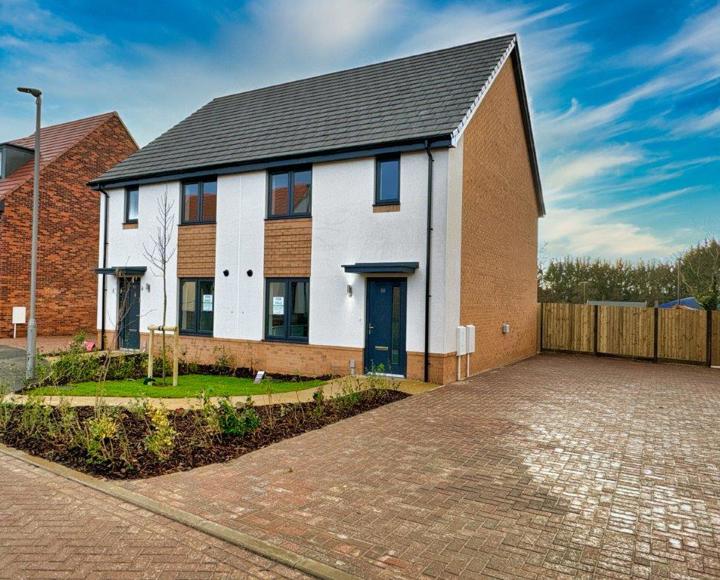 Picture showing the front of the semi-detached houses and parking spaces