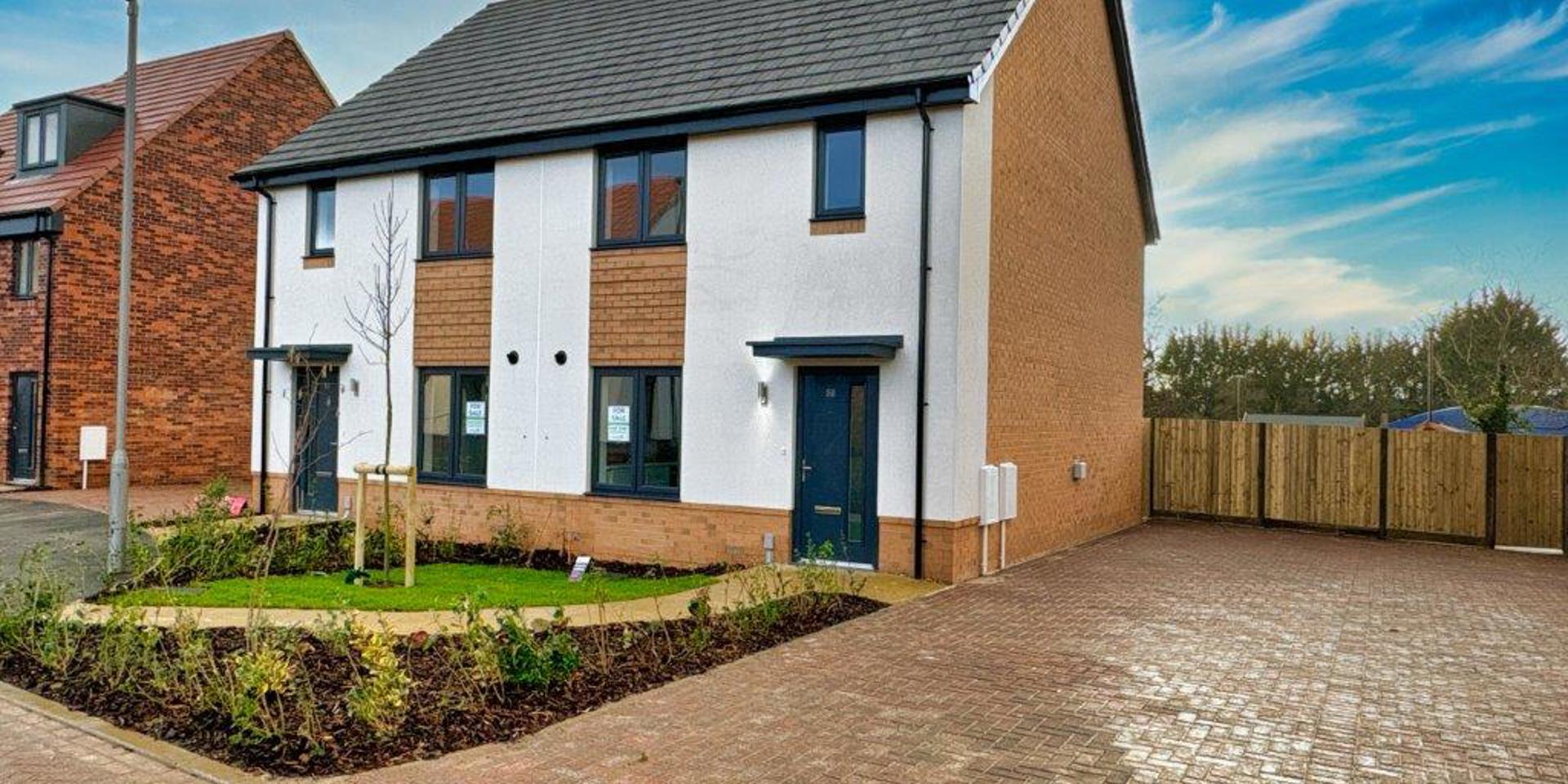 Picture showing the front of the semi-detached houses and parking spaces