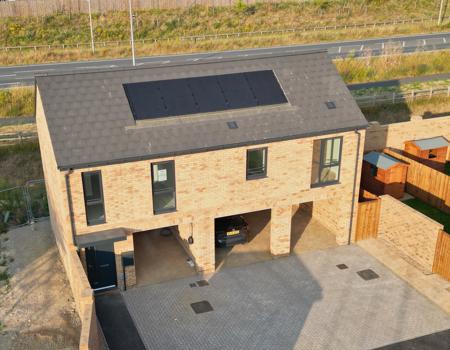 The coach house has 4 windows to the front, solar panels and 3 car port parking spaces