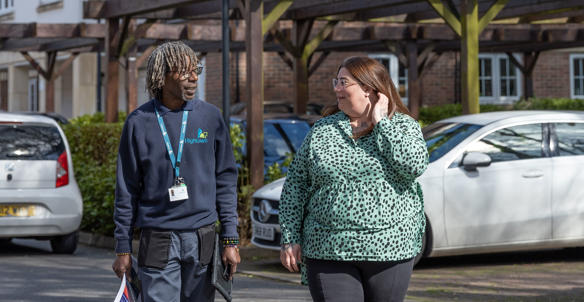 Property services inspector and a resident walking around the estate