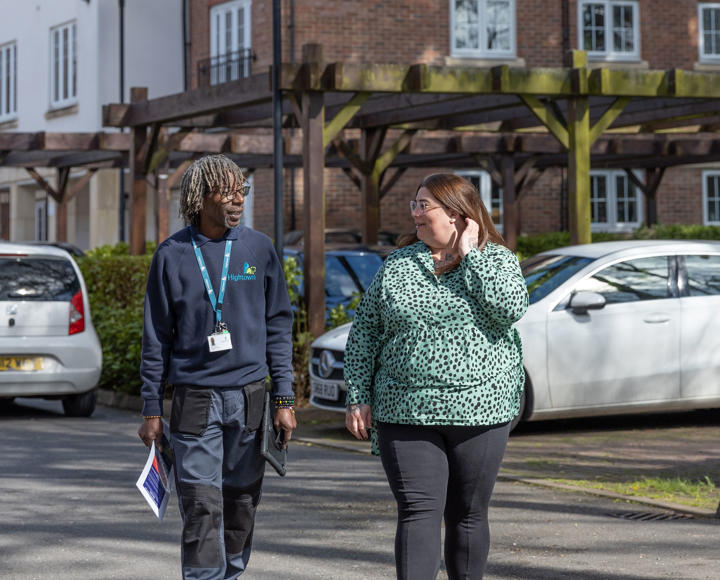 Property services inspector and a resident walking around the estate
