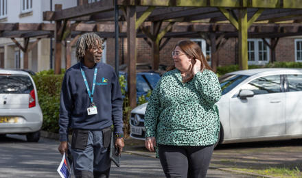 Property services inspector and a resident walking around the estate