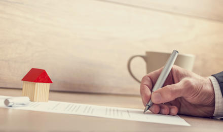 Someone filling in a form on a piece of paper to extend their lease for their shared ownership property