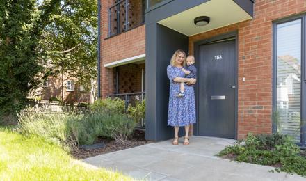 Hightown resident and young son outside their home