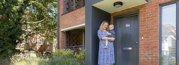 Hightown resident and young son outside their home