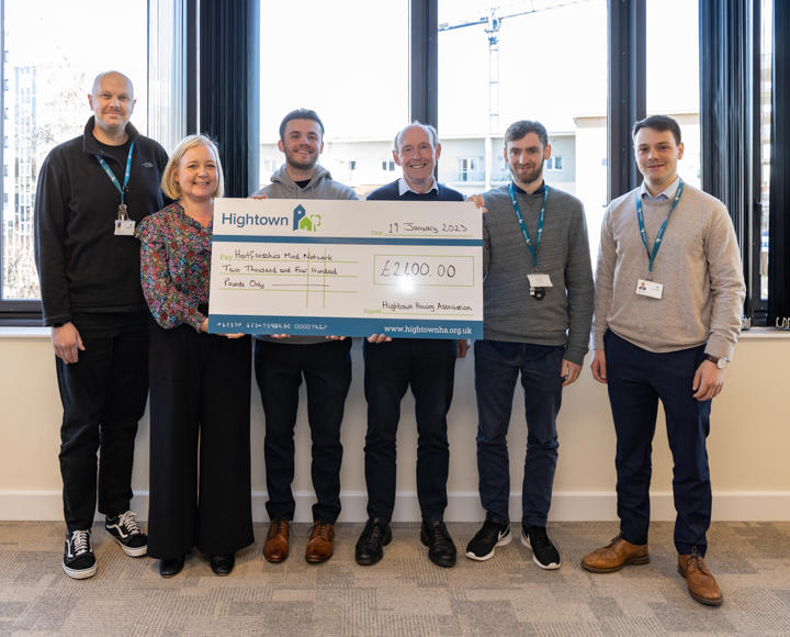 Members of Hightown's charity committee holding a large cheque. 
