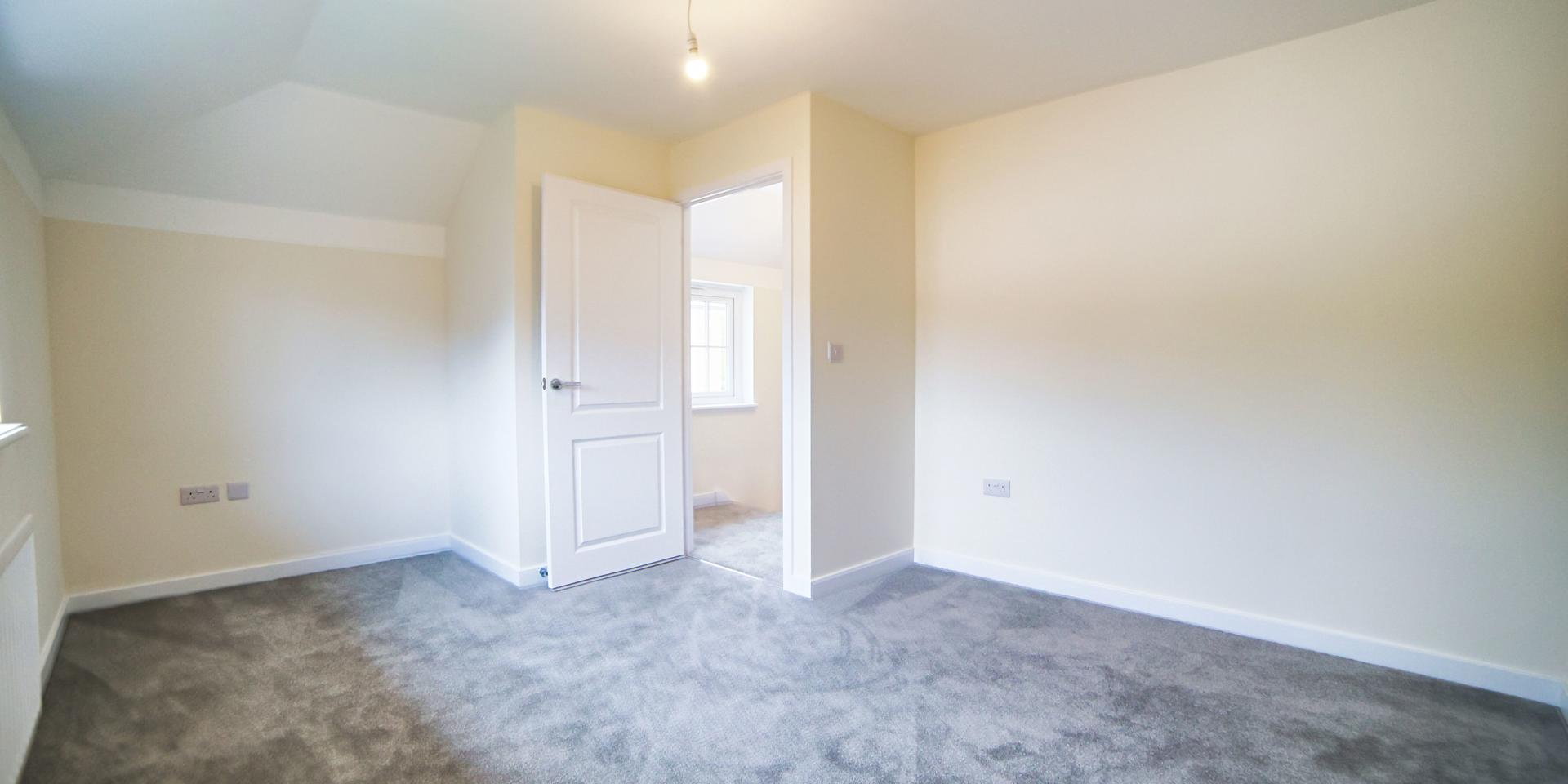 The main bedroom with slightly sloped ceilings