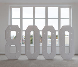 An '8000' sign, for the number of homes Hightown has delivered