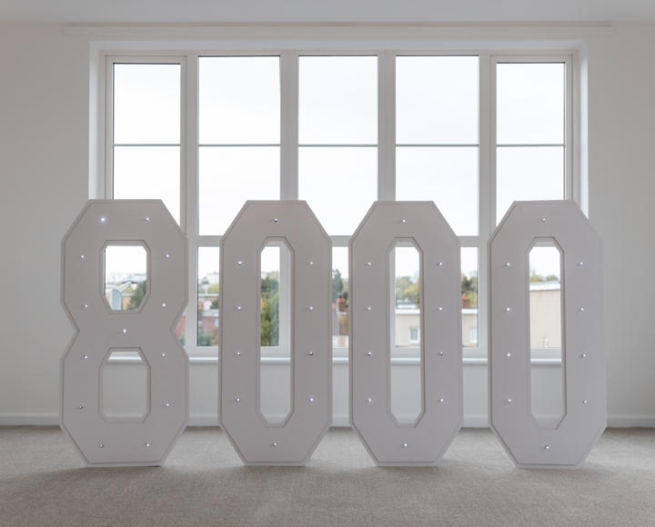 An '8000' sign, for the number of homes Hightown has delivered