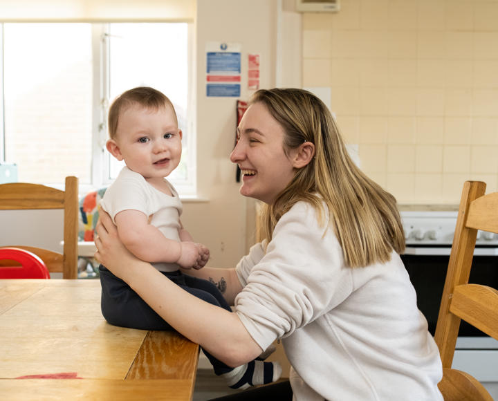 A mother sat with her young child at one of our care and supported housing schemes