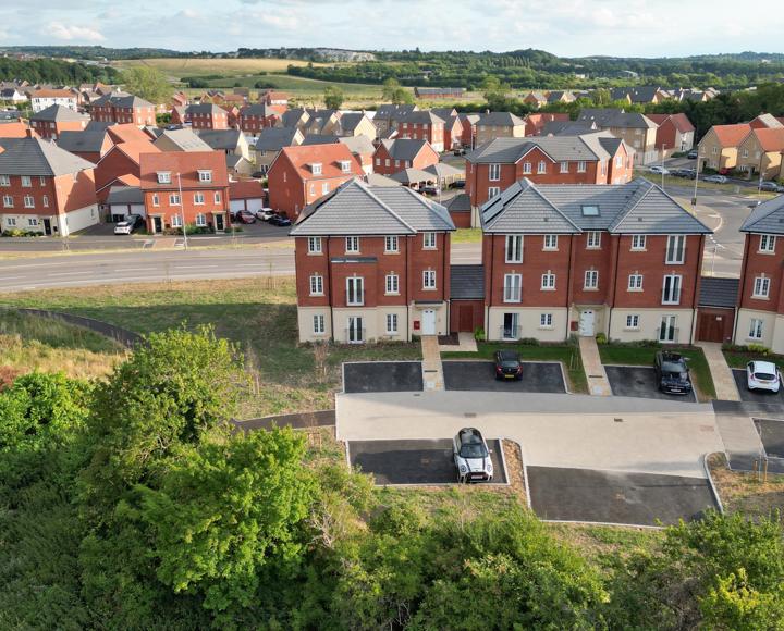 A photo of the back of the apartment block where the car park is located