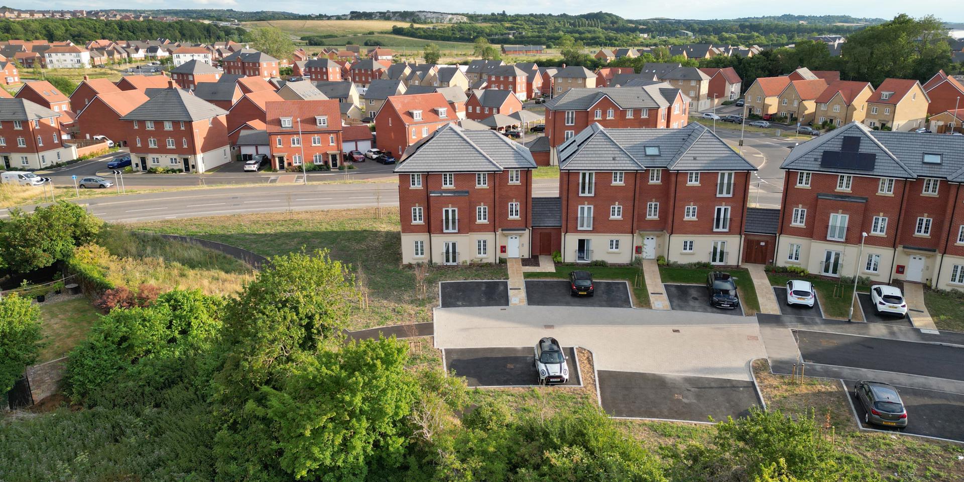 A photo of the back of the apartment block where the car park is located