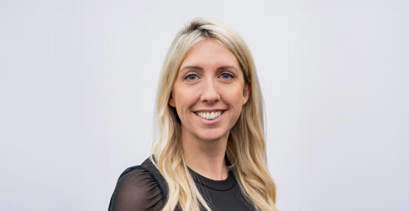 Headshot of Amy Laurie, Hightown's Director of Care & Supported Housing (job share). She is wearing a black blouse, has long blonde hair and blue eyes.