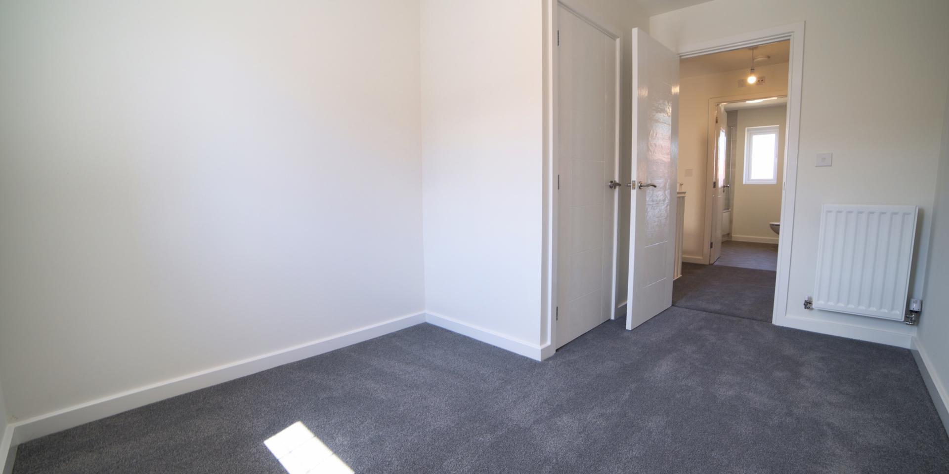 There is a built-in storage cupboard in the third bedroom