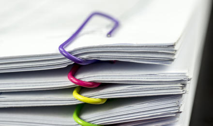 Multiple files held together by paperclips