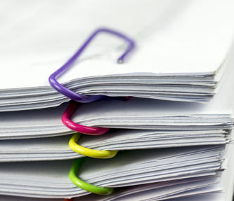 Multiple files held together by paperclips