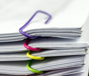 Multiple files held together by paperclips