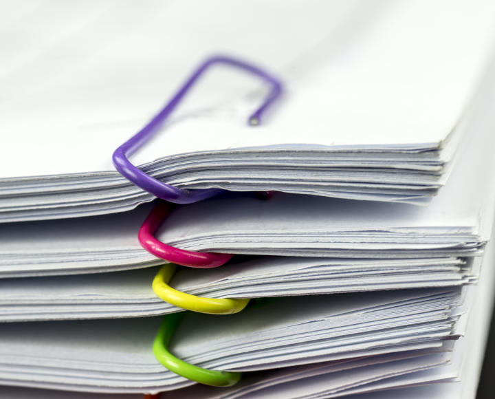 Multiple files held together by paperclips