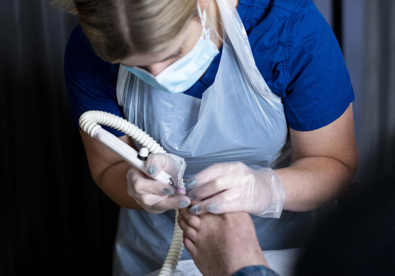 Podiatrist helping serive user at St Albans Hightown Homeless Event