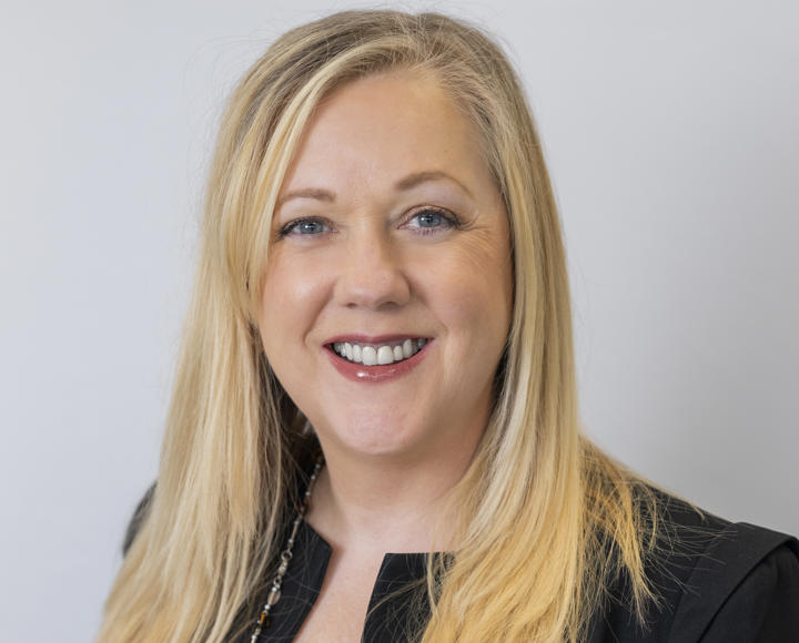 Leslie Channon (a board member) wearing a black top and jacket