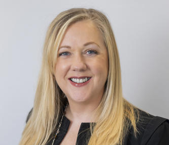 Leslie Channon (a board member) wearing a black top and jacket