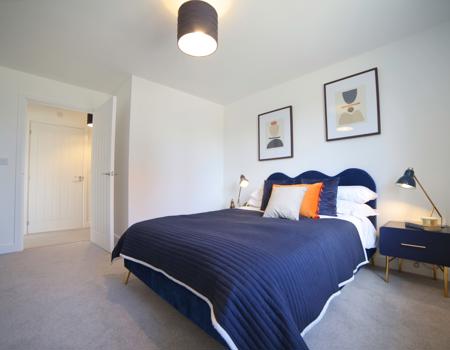 There are two bedside tables, a double bed, dressing table, stool and freestanding clothes rail in the bedroom