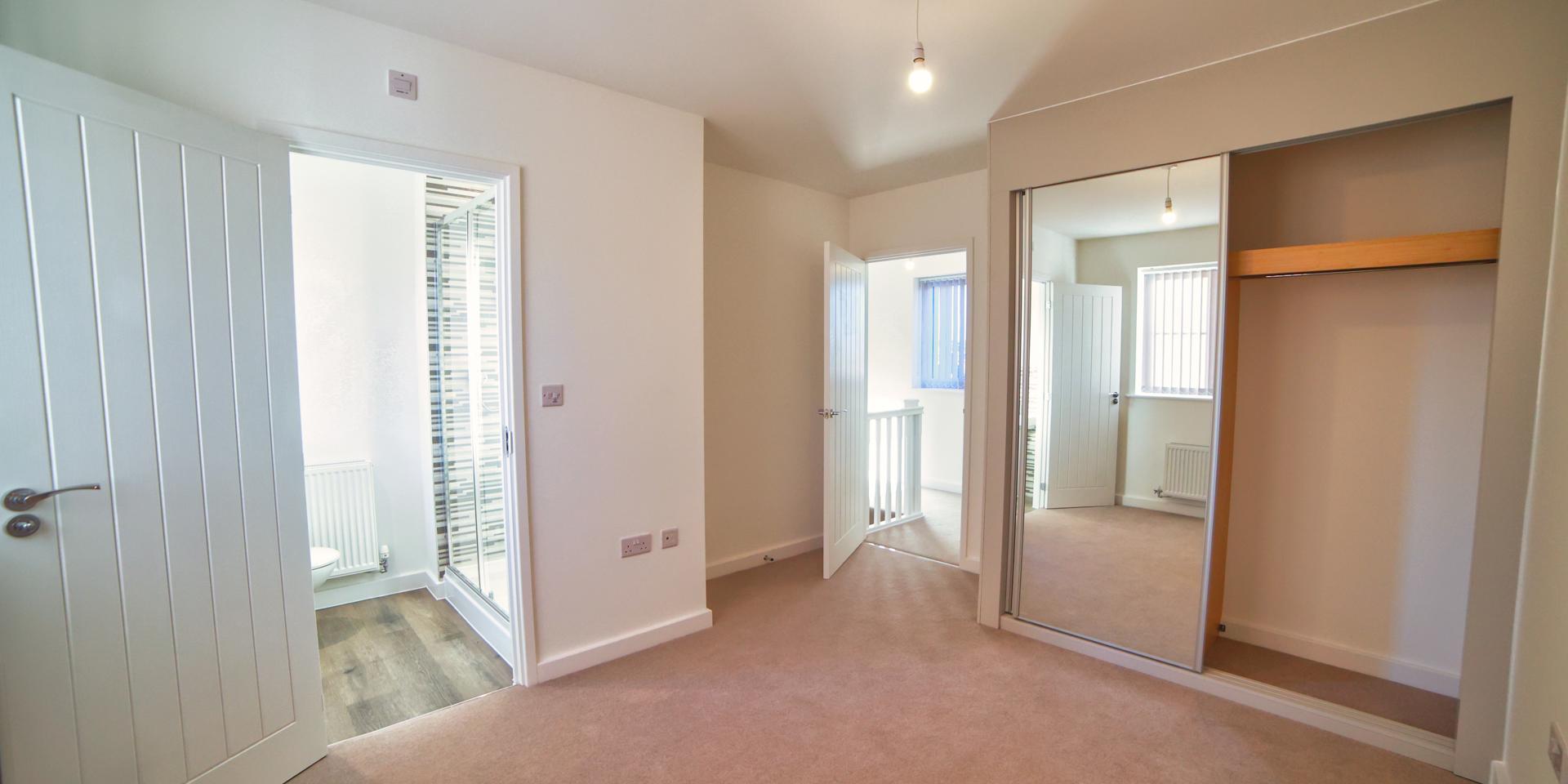The main bedroom has a built-in mirrored wardrobe